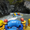 Tourists enjoying a thrilling rafting ride on the Otago Shotover River.
