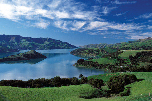 Scenic view of Akaroa Bays under a bright blue sky.