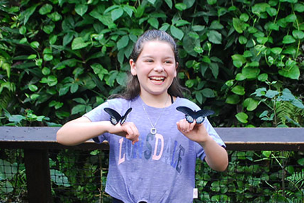 Girl having a great time with butterflies.