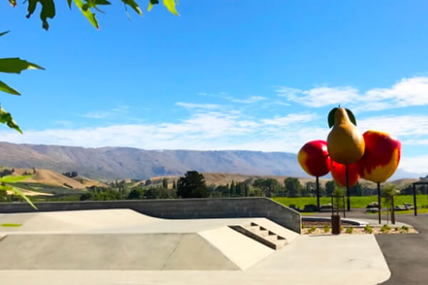 Skate park at Cromwell ovelooking mountain range on a sunny day.