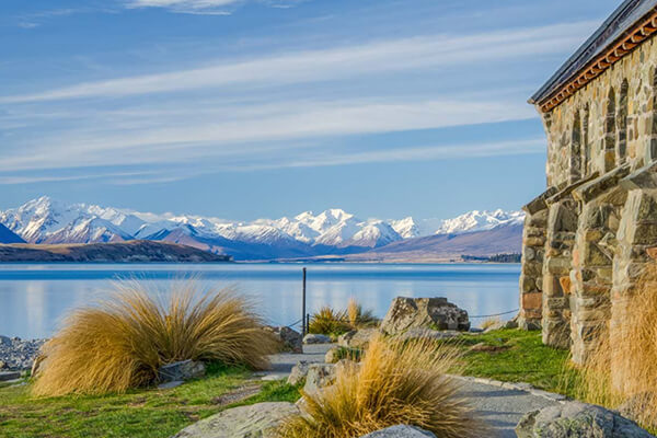 the Church of the Good Shepherd with the lake behind it and the view from the Mt John summit.