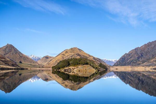 Spectacular view from Moke Lake with crystal clear waters on a sunny day.