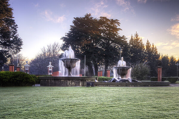 Water fountain at Queens Park at dawn.