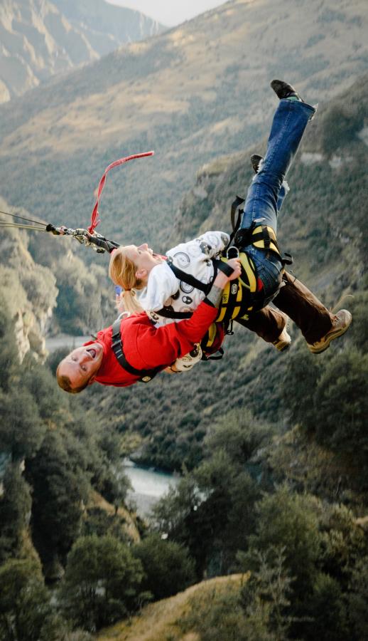 Two thrilled jumpers show off their Backwards Jump Style.