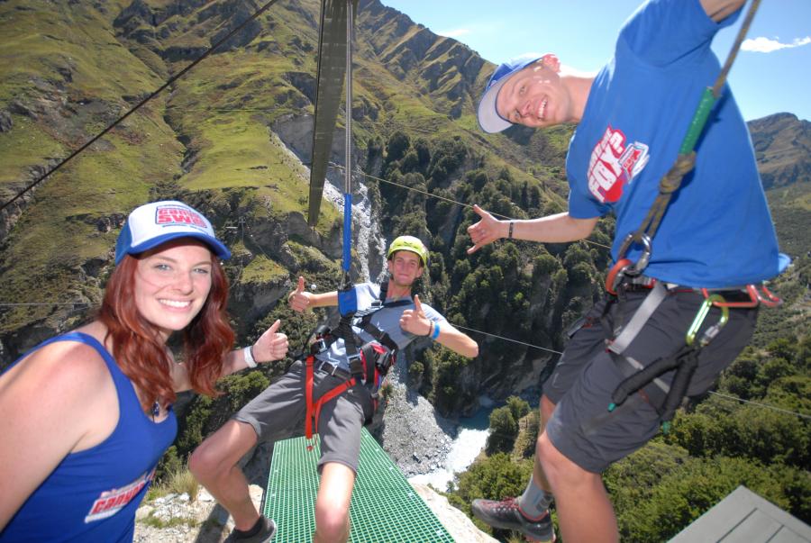 Three happy people getting ready to leap off the platform at Canyon Swing Queenstown