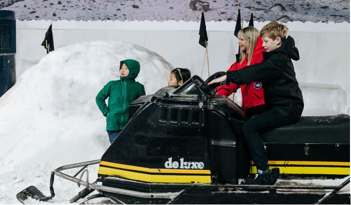 guide with children on a hagglund