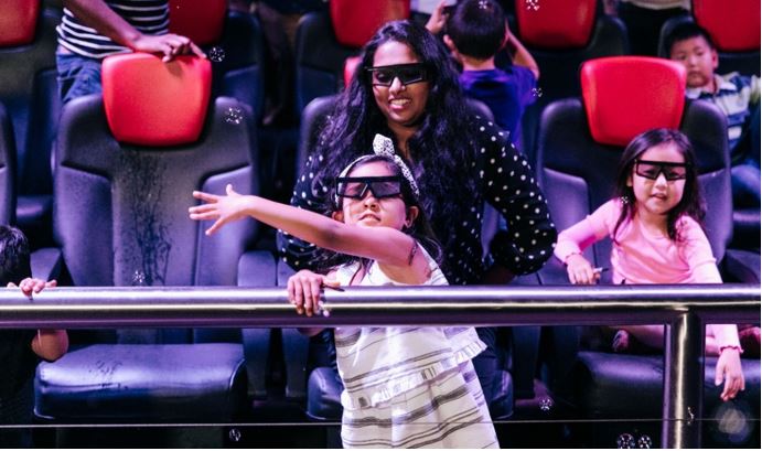 woman and child with 3D glasses in the 4D theater