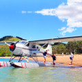 Tourists off boarding sea plane after a scenic tour of Auckland. 