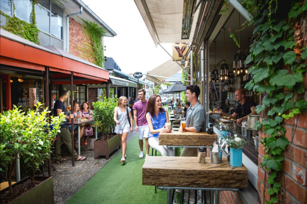 Shoppers roaming an alfresco dining area at an Auckland shopping centre.