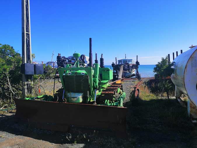 bulldozers ready to haul out fishing boats at Ngawi