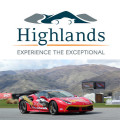 A red racing car at a Highlands Motorsport Park circuit.