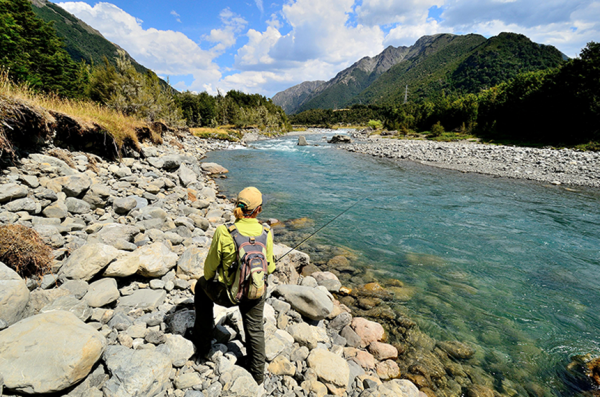 Man fishing at Owen River Lodge in Nelson, New Zealand.