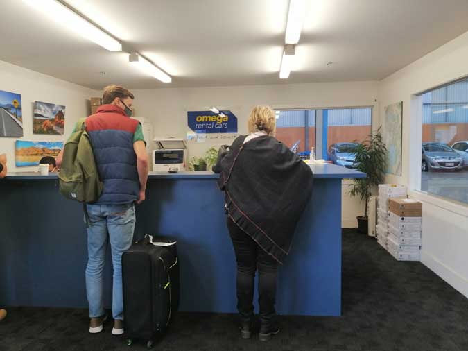 Two people inside rental car office