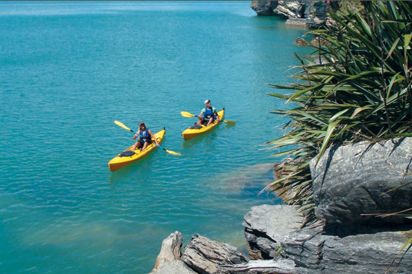 Two kayakers enjoying the beauty of Raglan.