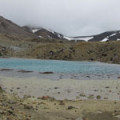 View near the Tongariro volcanic summit, with a foggy sky.