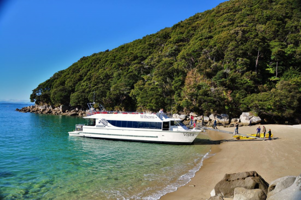 Tourists boarding a boat for a cruise along the Abel Tasman.