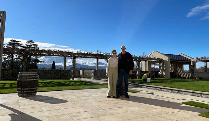 Two visitors to the Wither Hills Vineyard enjoy the sun.